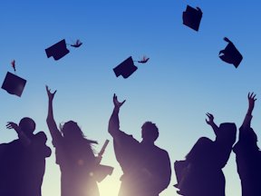 Graduates throw their academic caps in the air