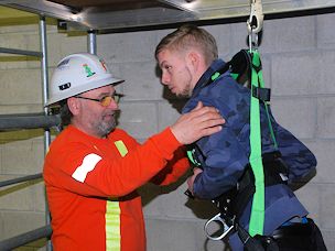 Worker wears harness during Working at Heights training