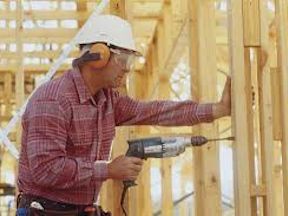 Construction worker drilling into wood