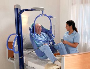 Man sitting in hospital bed while talking to nurse