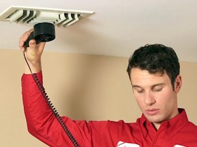Worker uses indoor air quality monitor