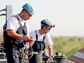 Workers working at heights with proper safety equipment