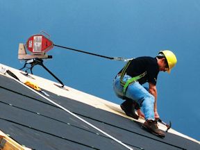 Roofer working on rooftop