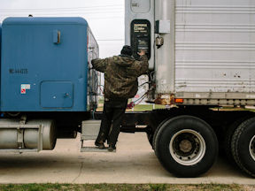Truck driver inspecting truck