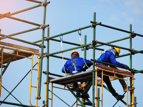 Workers working at heights with proper safety equipment