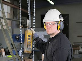 Worker wearing hardhat and earmuffs