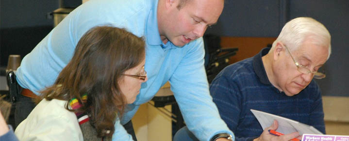 Workers reviewing WHSC's annual report