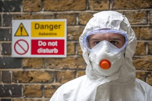 Worker wears safety goggles and mask