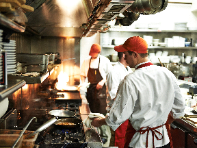 Young workers working in a kitchen