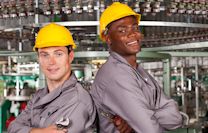 Two smiling construction workers wearing hard hats