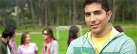 A young man standing in a park learning about occupational health and safety for young workers