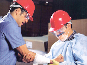 A supervisor looks at a worker's injured arm