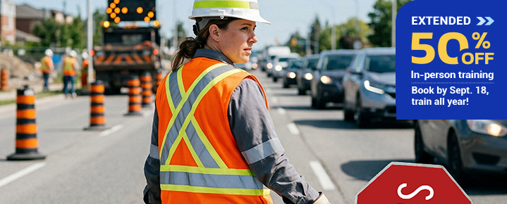 Traffic control worker applying skills after traffic control training on a road construction site.