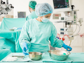 Ontario nurse using disinfectant at work