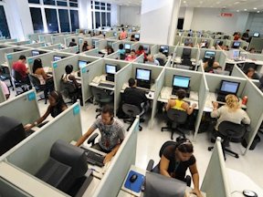 Call centre workers working in small cubicles