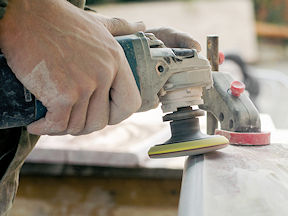 Worker sanding a stone countertop