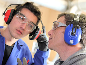 Two workers wearing earmuffs