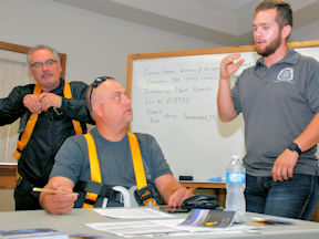 WHSC instructor helps small group of participants in Working at Heights training class