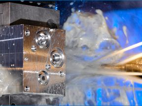 A high-tech automated machine drills precise holes into a block of solid aluminum