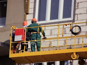 Workers on a swing stage platform