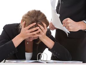 Worker holds head in her hands after being bullied